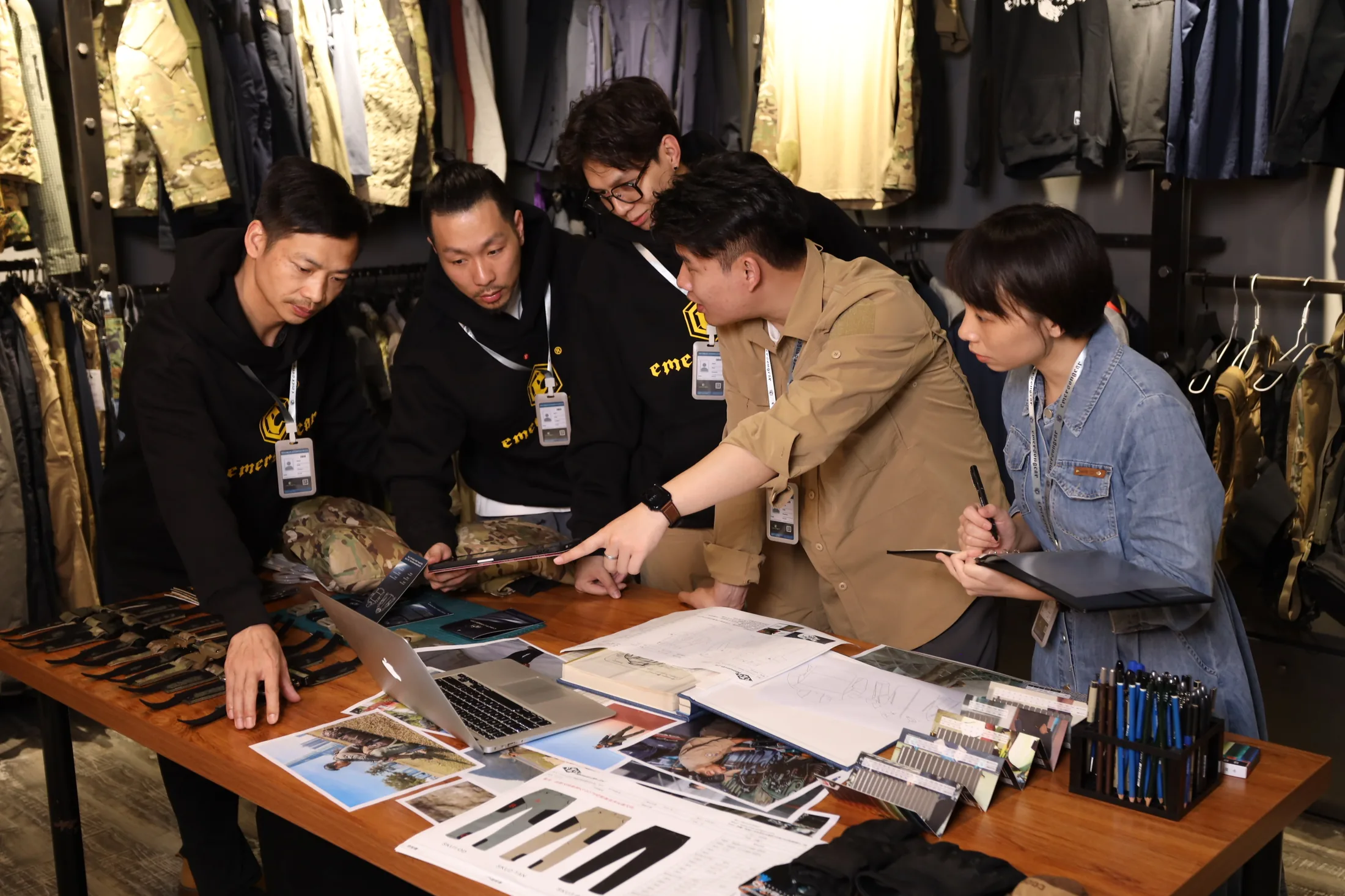 Emersongear product team reviewing tactical apparel samples and design materials