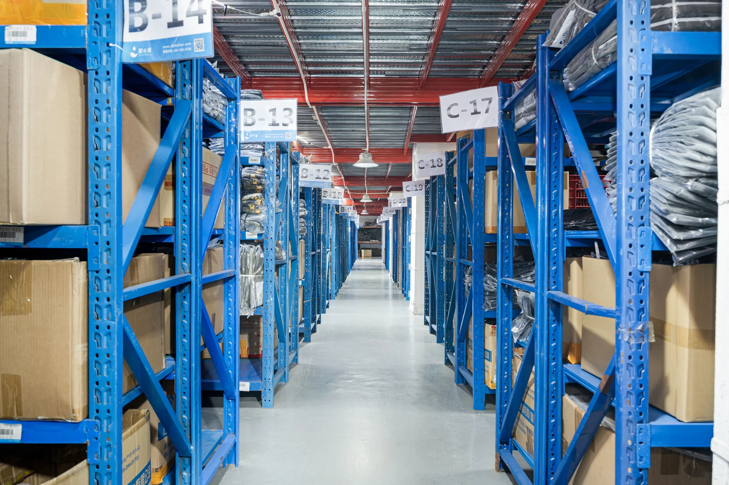 Organized Emersongear warehouse with blue labeled storage aisles and boxed inventory